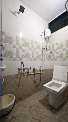 a bathroom with a toilet and a shower at Redwing Peaceful Studio in Navi Mumbai