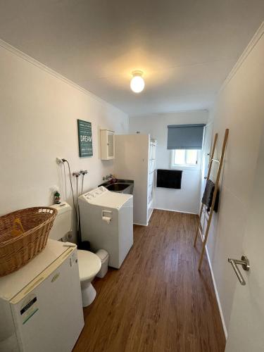 a bathroom with a toilet and a sink at Saturn Parade Shack in Venus Bay
