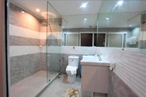 a bathroom with a toilet and a shower and a sink at DelMar by Mery World Hospitality in Pattaya South