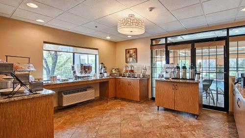 a large room with a counter with glasses on it at Comfort Inn & Suites Copley Akron in Copley
