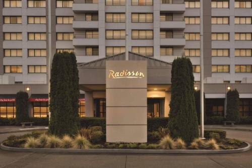 a building with a hotel sign in front of it at Radisson Hotel Seattle Airport in SeaTac