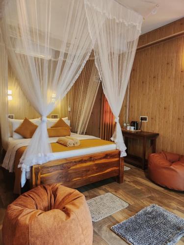 a bedroom with a bed with a canopy at Tea Brook Lodge Ella in Ella