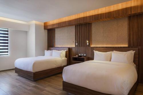 Llit o llits en una habitació de Radisson Puebla Angelopolis