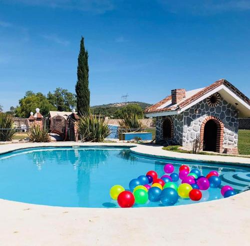 a pool filled with colorful balloons in front of a house at Casa Jardín Santiago in Texcoco de Mora