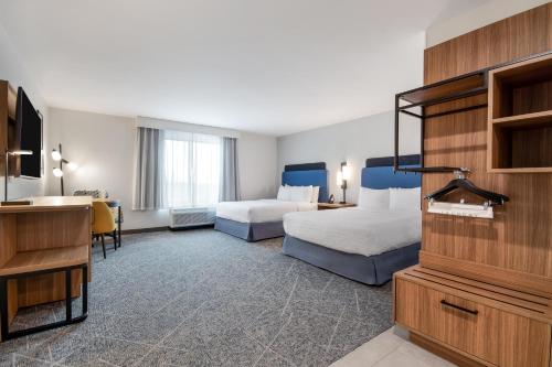 a hotel room with two beds and a desk at Hampton Inn & Suites By Hilton Irving Dfw Airport North in Irving