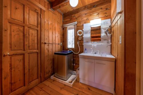 a bathroom with a sink and a toilet in a wooden room at Log village FIKA / Nasu / Woodstove / Starry sky in Nasu