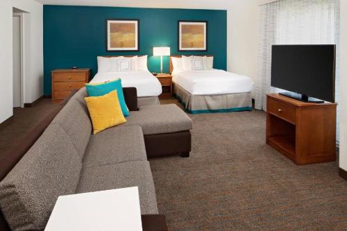 a living room with a couch and a bed and a tv at Residence Inn by Marriott Harrisburg Hershey in Harrisburg