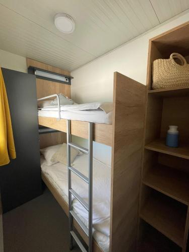a small room with a bunk bed in it at Mobile Home River in Privlaka