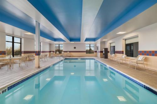 a large swimming pool with chairs and tables at Hampton Inn and Suites - Lincoln Northeast in Lincoln