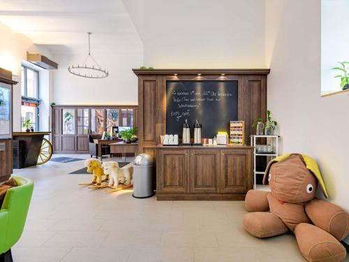 a room with stuffed animals sitting on the floor at Ibis Styles Trier in Trier