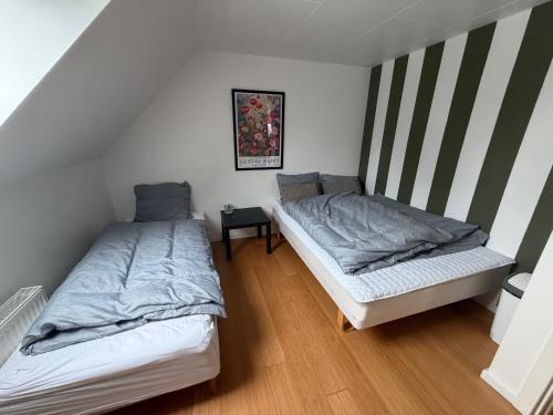 a room with two beds in a attic at Kystvejen Øster Hurup in Hadsund