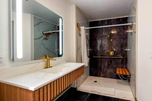 a bathroom with a sink and a shower at Rodeway Inn Encinitas North in Encinitas