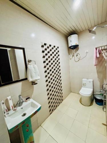 a bathroom with a sink and a toilet at Oliva by Quercus Oak Stays in Mussoorie