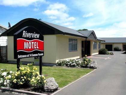 a motel sign in front of a house at Riverview Motel in Whanganui