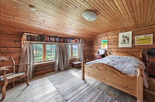 a bedroom with a bed and a wooden ceiling at Staurset gård in Mittet