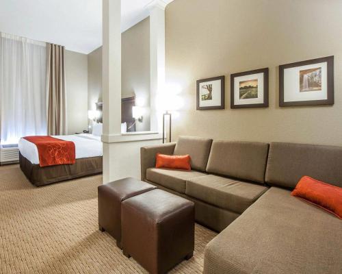 a hotel room with a couch and a bed at Comfort Suites Marietta-Parkersburg in Marietta