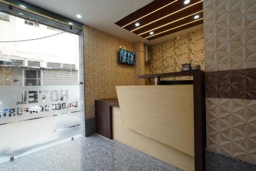a lobby with a wooden door and a window at Golden Comforts Banglore in Bangalore