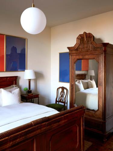 a bedroom with a large bed and a mirror at La Giardina Guest House in Chieri