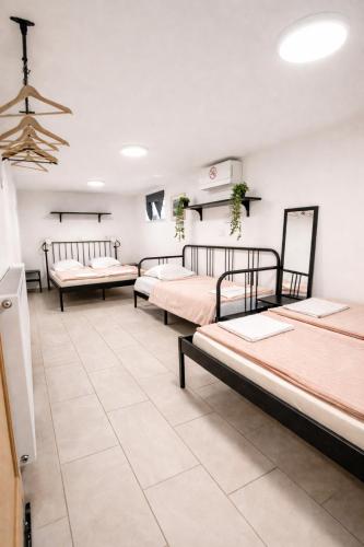 a room with four beds in it at Apartma Licko in Domžale