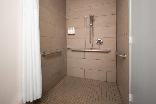 a bathroom with a shower with a tiled floor at Wingate by Wyndham Los Alamos in Los Alamos