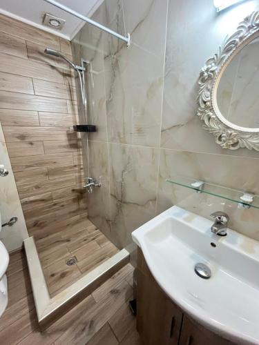 a bathroom with a shower and a sink at Guesthouse Liogerma in Kato Loutraki