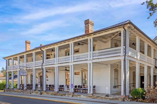 a white house with white columns at The Colonial Inn, an Ascend Collection Hotel in Hillsborough
