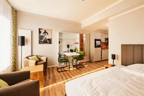 a bedroom with a bed and a living room at ADAPT APARTMENT HOTEL Siegen in Siegen