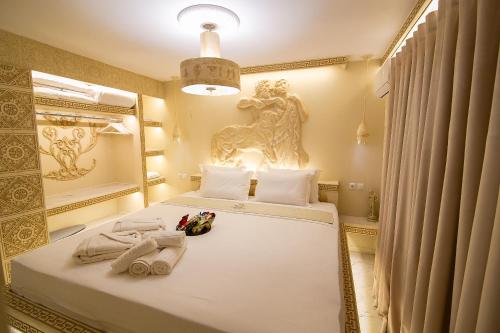 a bedroom with a bed with towels and a mirror at CENTAURIA Greek Luxury Suite 5' Port Gate 7-8 & Cruises Gate 11-12 in Piraeus