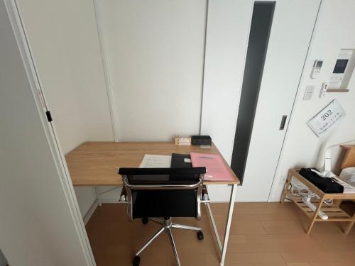 a small room with a desk and a chair at One Point Five in Tokyo