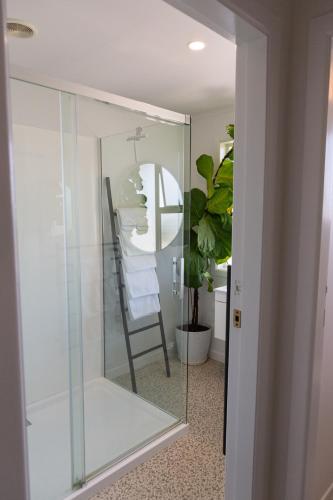 a glass closet with a chair in a room at Townhouse on Courtenay in New Plymouth