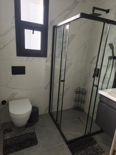 a bathroom with a shower and a toilet and a sink at Caesar Resort, Epictetus,Iskele, North Cyprus in Iskele