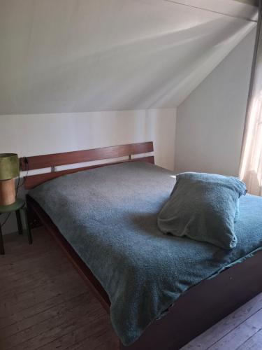 a bedroom with a bed with a pillow on it at Huis aan Puyenbroeck in Wachtebeke