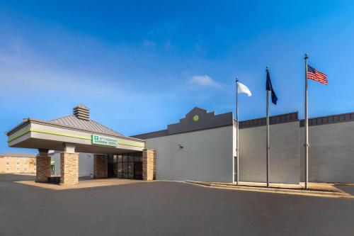 a building with two flags in front of it at Wyndham Garden Detroit Metro Airport in Romulus