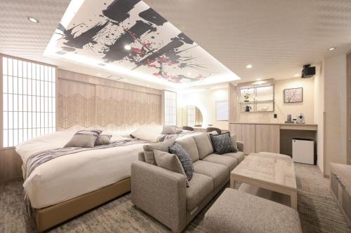 a bedroom with a large bed and a couch at HOTELみなと-Minato- 新宿 in Tokyo