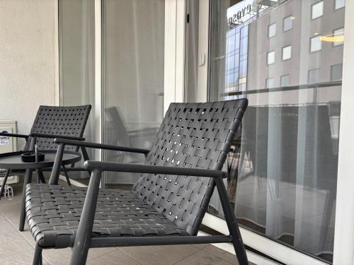 two chairs sitting on top of a balcony at Premier Hotel Miskolc in Miskolc