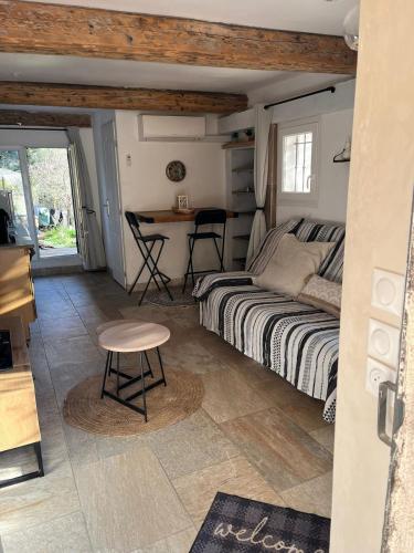 a bedroom with a bed and a desk and a table at Studio avec double terrasse Roquefort les Pins in Roquefort-les-Pins