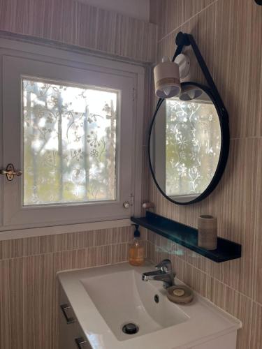 a bathroom sink with a mirror and a window at Studio avec double terrasse Roquefort les Pins in Roquefort-les-Pins