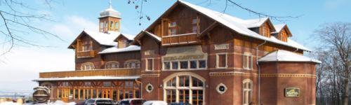 a large building with snow on top of it at Berg-Gasthof Honigbrunnen in Löbau