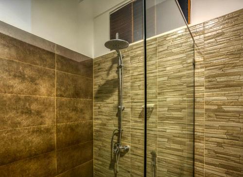 a shower with a glass door in a bathroom at Villa Barracuda in Sri Jayewardenepura Kotte