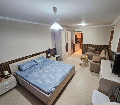 a bedroom with a bed and a living room at Blue Marina Sunset in Sozopol