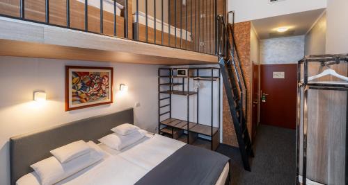 a bedroom with a bunk bed and a staircase at Best Western Airport Hotel Stella in Zagreb