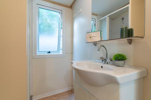 a bathroom with a sink and a window at Club del Sole Roseto degli Abruzzi Easy Camping Village in Roseto degli Abruzzi