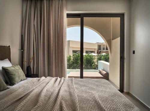 a bedroom with a bed and a large window at Admiral De Luxe in Zakynthos