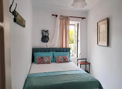 a bedroom with a bed in a room with a window at Parga Center Apartment in Parga