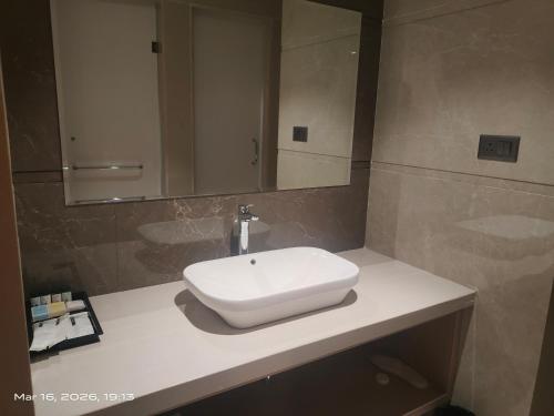 a white sink on a counter in a bathroom at Shagun Hotel & Resorts in Khandwa
