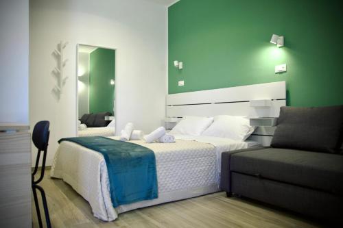 a bedroom with a large bed and a couch at Residenza Villa Terry in Vieste