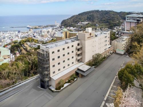 an aerial view of a building with the ocean in the background at KAMENOI HOTEL Atami Annex in Atami
