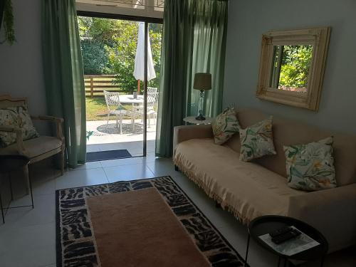 a living room with a couch and a sliding glass door at Milkwood Haven in Pennington