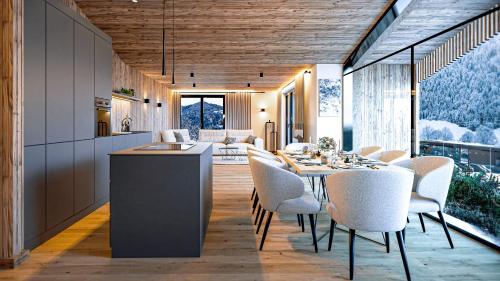 a kitchen and dining room with a table and chairs at Wieshof Wilder Kaiser by ALPS RESORTS in Söll
