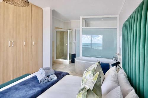 a bathroom with a bed and a bath tub at Sunset View 23 in Langstrand